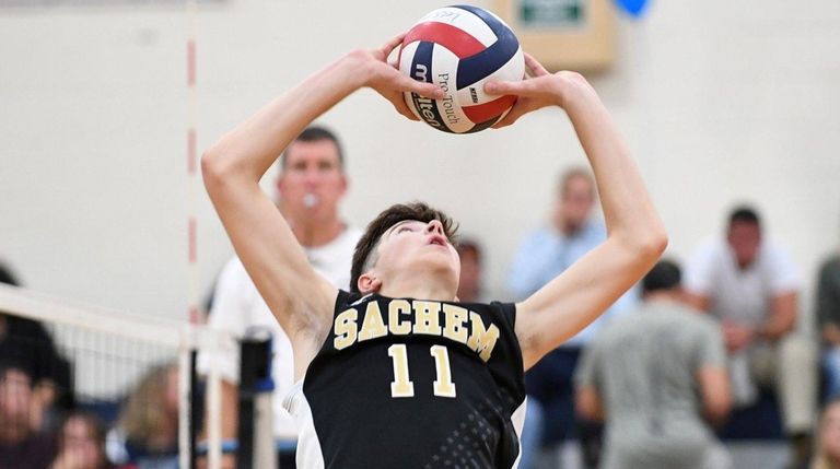 Sachem North's Jack Driscoll (11) sets the ball