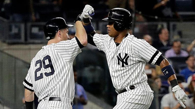 Yankees' Starlin Castro , right, and Todd Frazier high-five