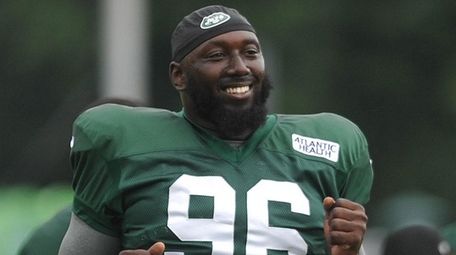 Jets' Muhammad Wilkerson stretches during training camp at the