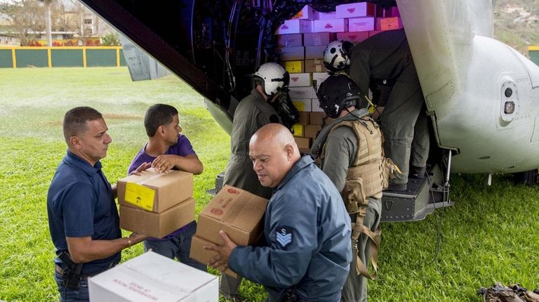 Marines unload food from a military aircraft in
