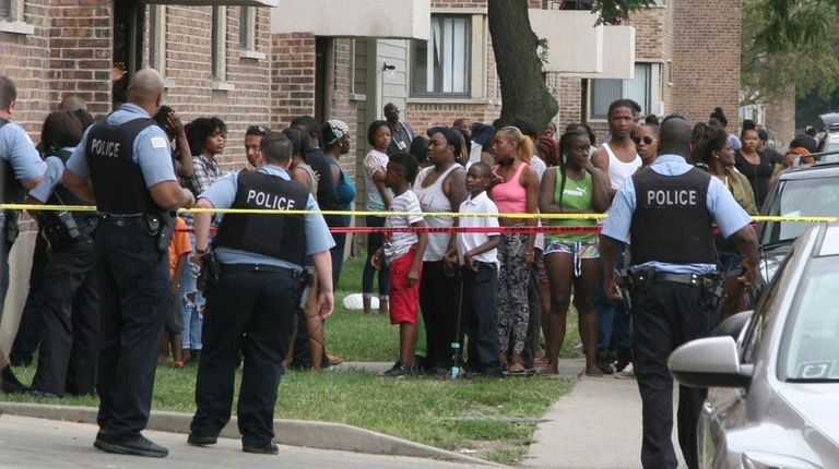 Police investigate the scene of a shooting in