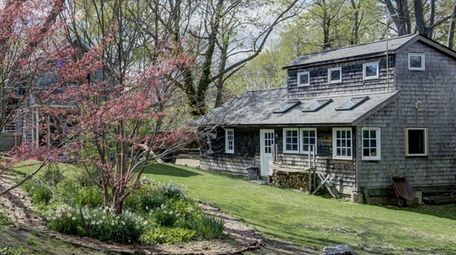 The Greenport property is planted with mature trees