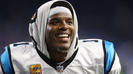 Cam Newton of the Panthers jogs off the
