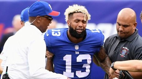 Giants receiver Odell Beckham Jr. is assisted onto