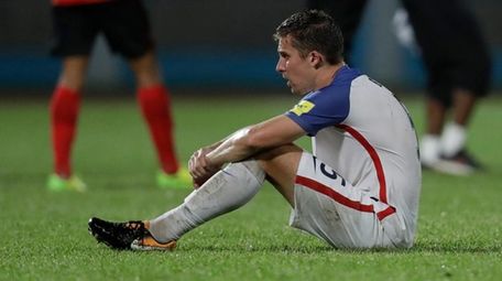 United States' Matt Besler, squats on the pitch