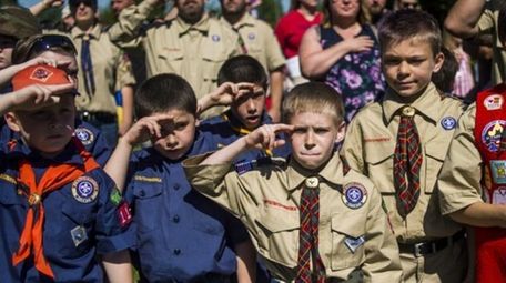 Boy Scouts and Cub Scouts salute during a