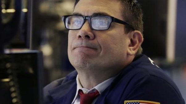 The screens of specialist Robert Tuccillo are reflected