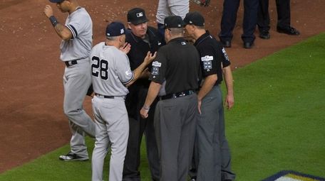New York Yankees Joe Girardi speaks with umpires