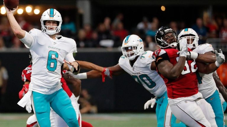 Dolphins quarterback Jay Cutler throws the ball under