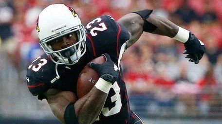 Cardinals running back Adrian Peterson runs with the