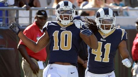 The Rams' Pharoh Cooper, left, celebrates his 103-yard