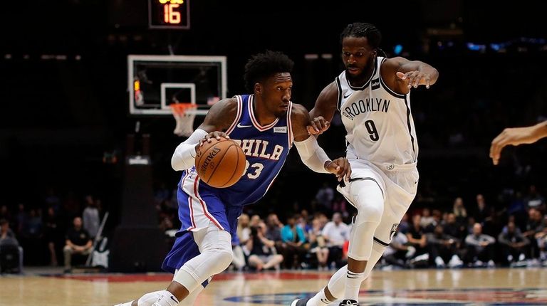 Philadelphia 76ers forward Robert Covington drives against Brooklyn