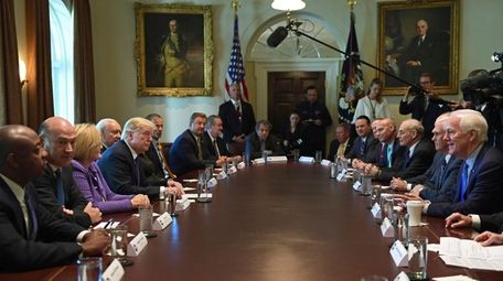 President Donald Trump, center left, meets with members