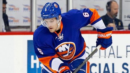 Islanders defenseman Ryan Pulock plays the puck during the first