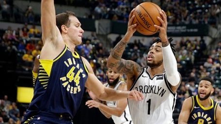 Nets guard D'Angelo Russell drives on Pacers forward Bojan