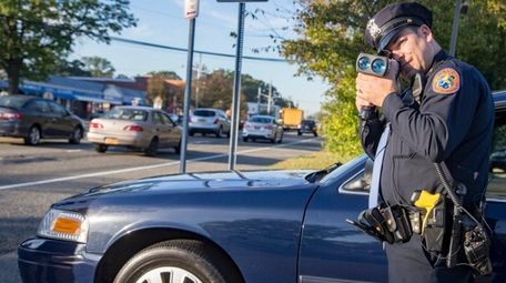 Nassau County Police Officer Todd Atkin conducts controlled