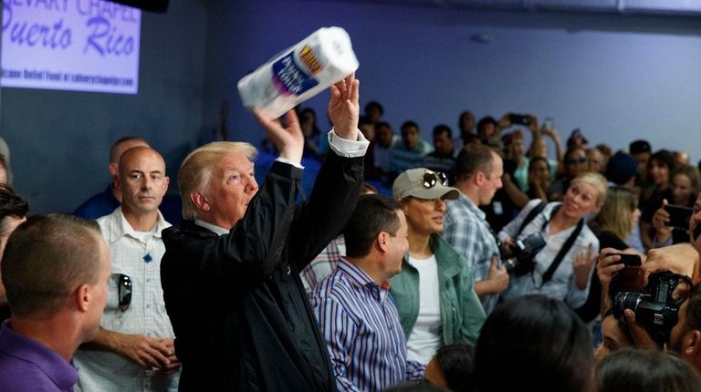 President Donald Trump tosses paper towels into a