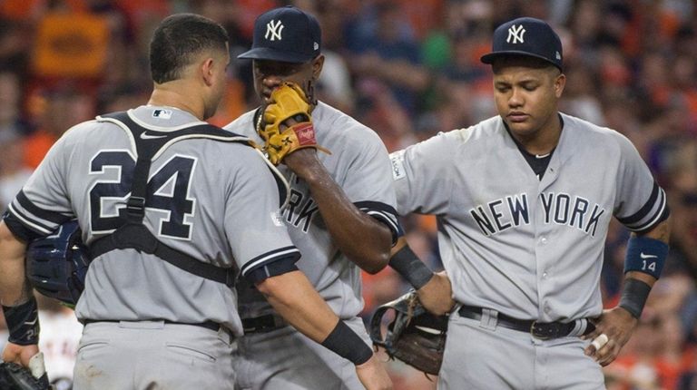 Luis Severino speaks with catcher Gary Sanchez and