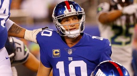 Eli Manning of the Giants looks on with