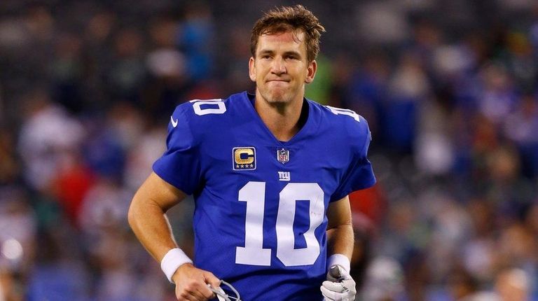 Eli Manning of the Giants runs off the