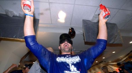 Adrian Gonzalez celebrates in the locker room after