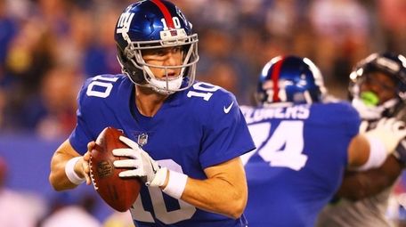 Eli Manning of the Giants looks to pass against the
