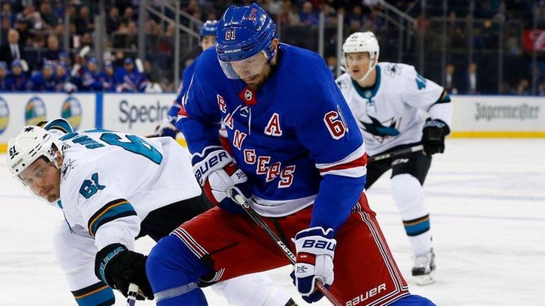 Rick Nash of the Rangers tries to bring