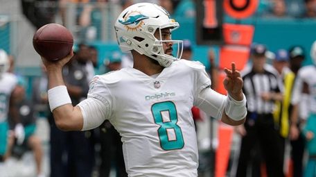 Dolphins quarterback Matt Moore looks to pass during a