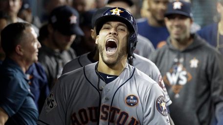 The Astros' George Springer celebrates after hitting a