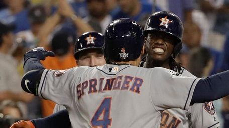 The Astros' George Springer celebrates after a two-run
