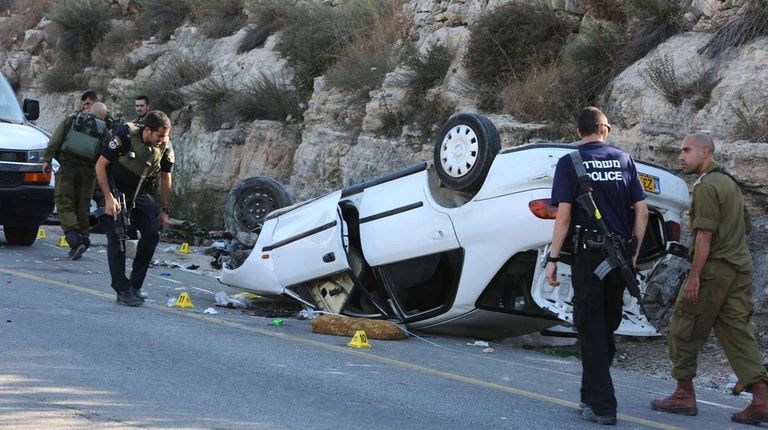 Israeli forensic police and security forces inspect the