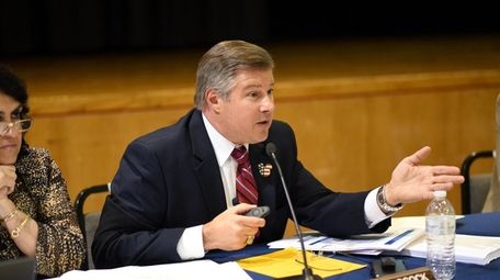 Massapequa Deputy Superintendent Alan Adcock speaks at a