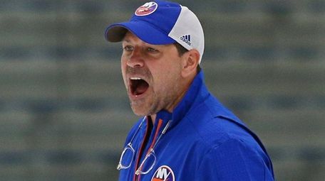 Islanders head coach Doug Weight looks on during practice