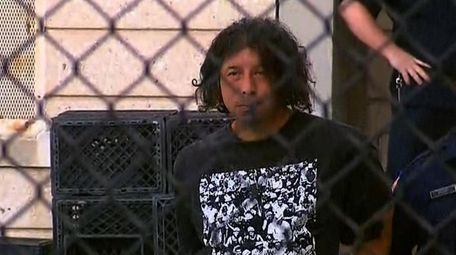 Luis De Jesus, 42, is escorted out of