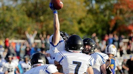 Centereach players mob Jesse Distasio after he scored the winning