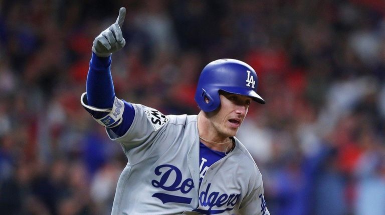 The Dodgers' Cody Bellinger reacts after hitting an RBI double