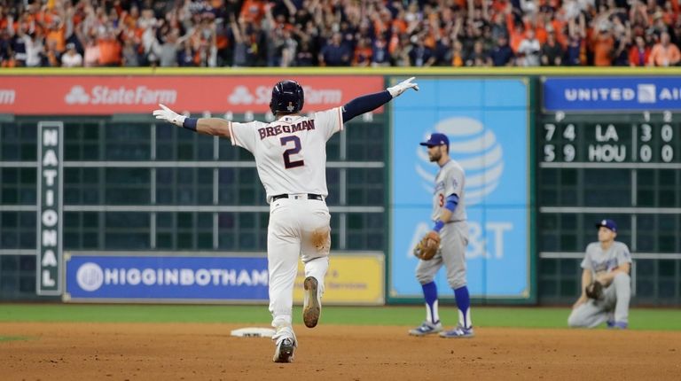Houston Astros' Alex Bregman reacts after hitting in