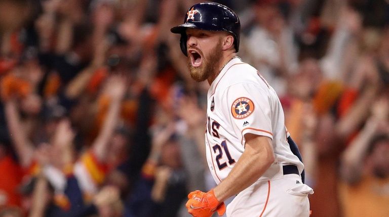 Derek Fisher of the Astros celebrates after scoring