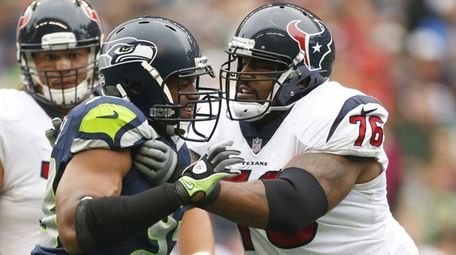 Duane Brown of the Texans blocks Dwight Freeney
