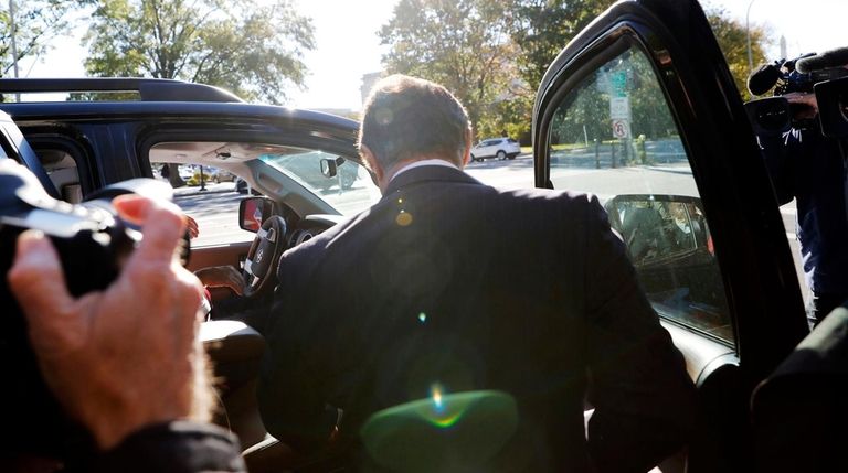 Paul Manafort gets into a car as he