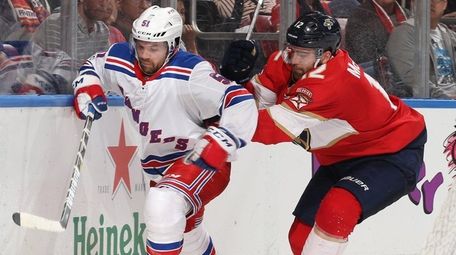 The Rangers' David Desharnais is pursued by the Panthers' Ian