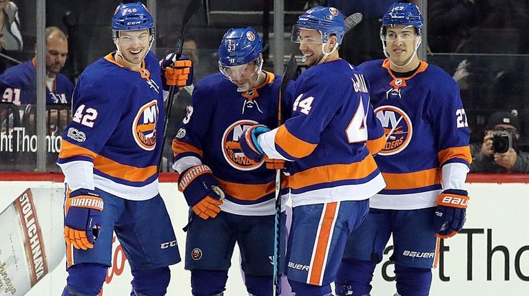 Islanders defenseman Scott Mayfield is congratulated by teammates