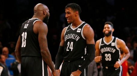 Rondae Hollis-Jefferson and Quincy Acy of the Nets react after