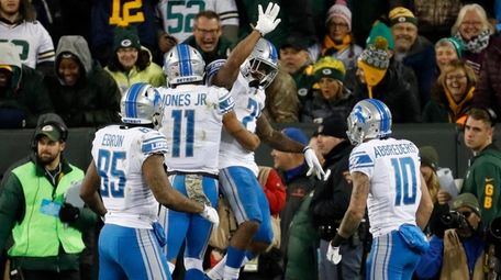 The Lions' Ameer Abdullah celebrates his touchdown run