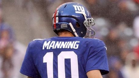 Giants quarterback Eli Manning walks off the field