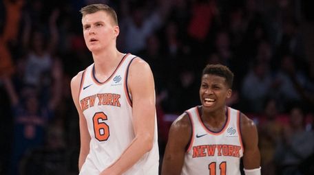 Knicks guard Frank Ntilikina celebrates forward Kristaps Porzingis' basket