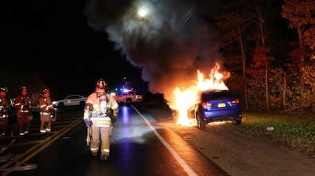 Firefighters respond to a vehicle fire early Friday, Nov.