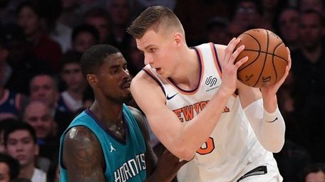 Knicks forward Kristaps Porzingis is defended by Charlotte
