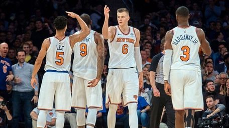 Knicks forward Kristaps Porzingis celebrates with teammates during a