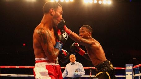 Tyrone James (6-0), from Elmont, lands a left